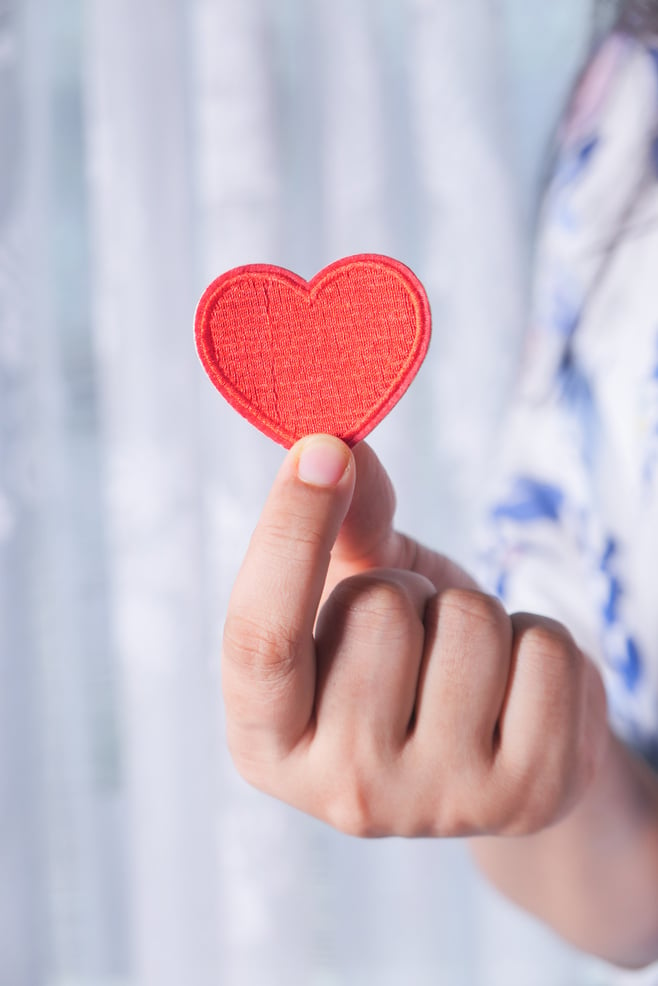 Women Holding Red Heart in Hands Close up